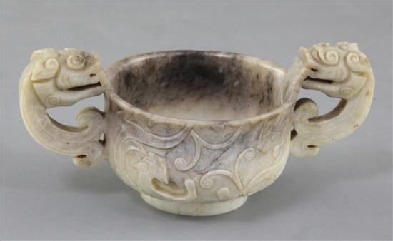 A Chinese cream and black jade two handled cup, 16th/17th century, width 13cm